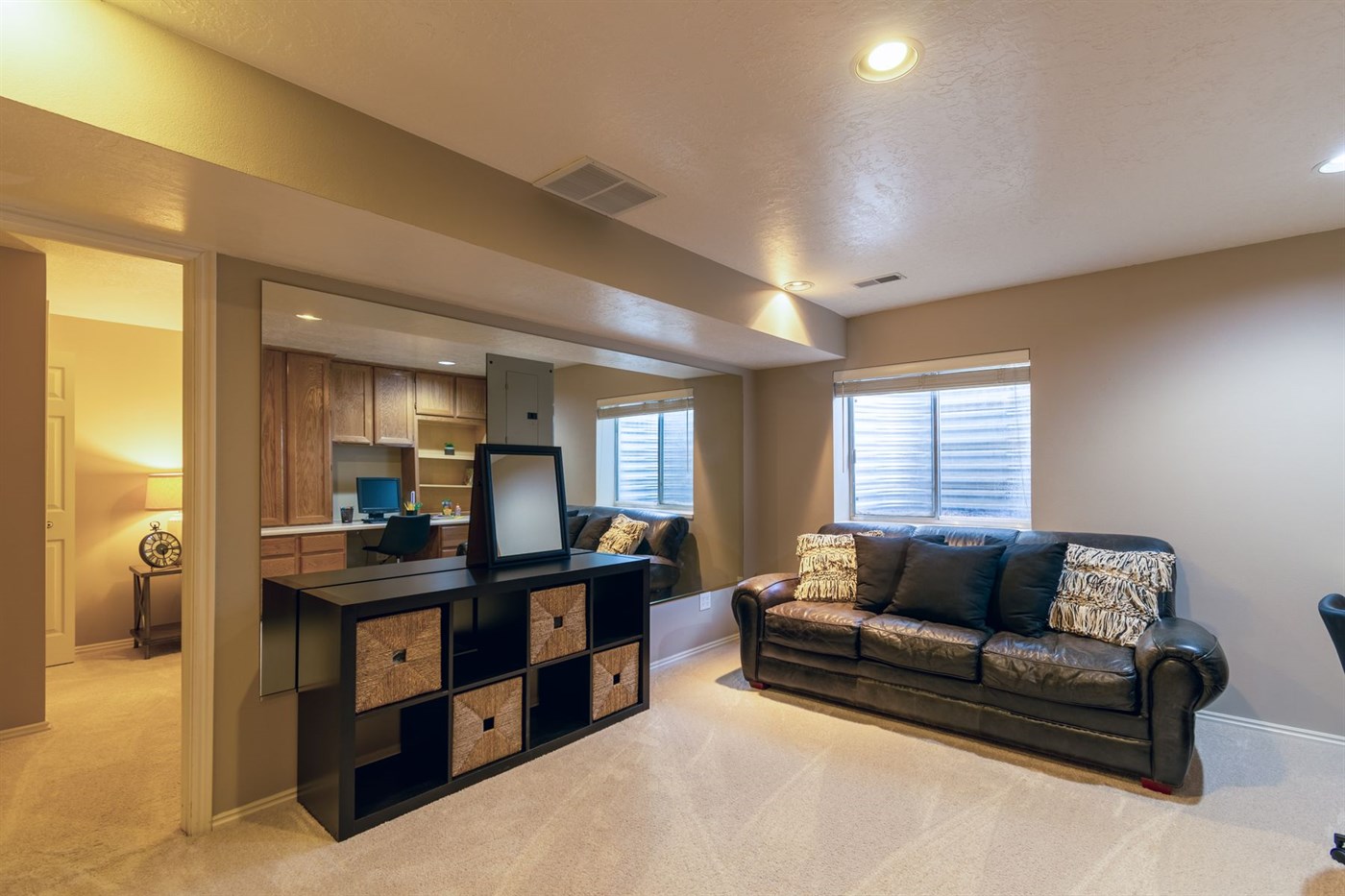 A finished basement room with clear floor space and nothing stacked against the walls
