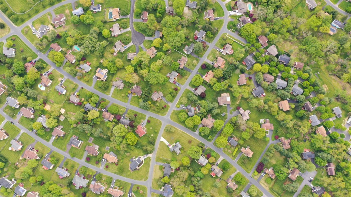 Overhead view of a leafy Maryland suburb: detached houses, driveways, garages and long back gardens